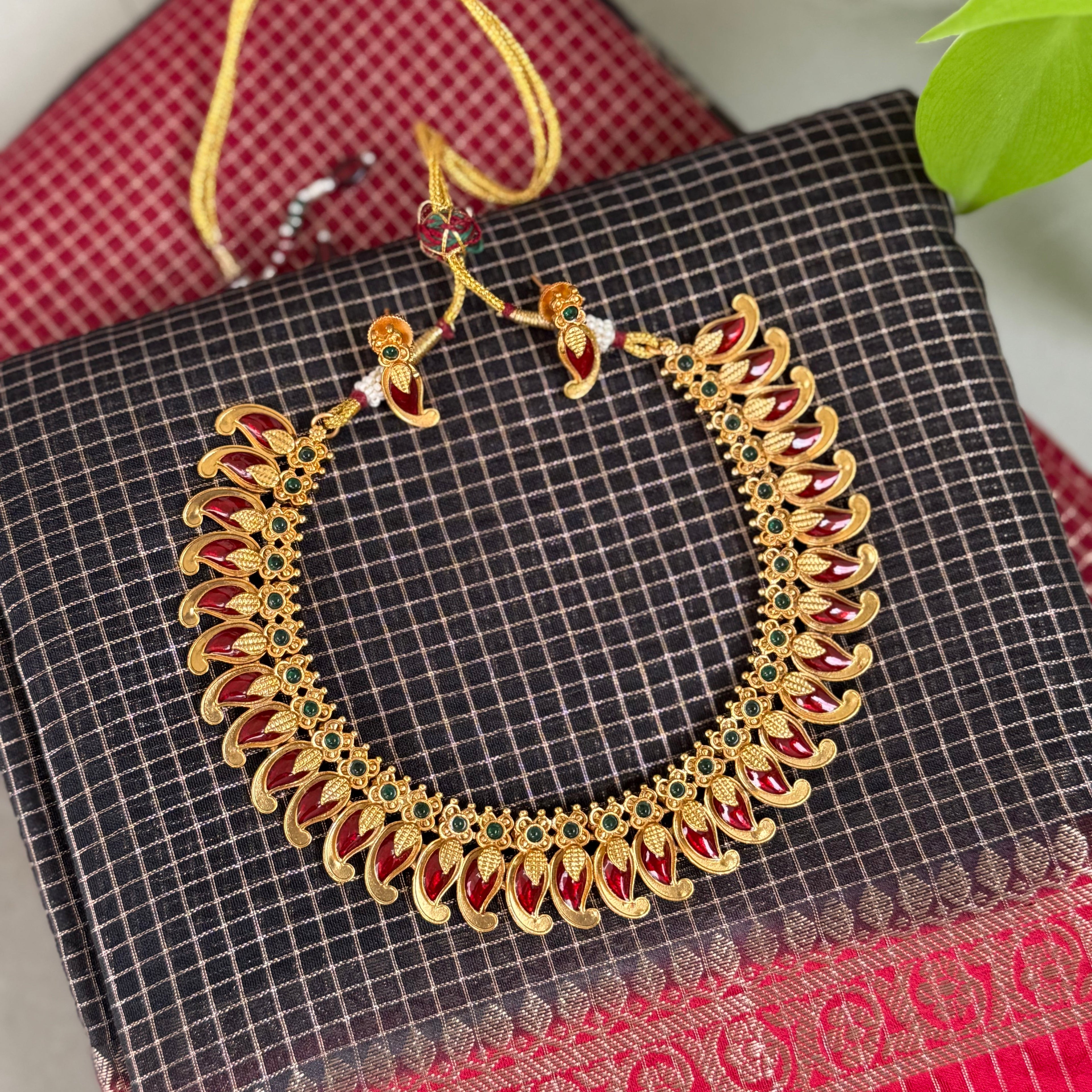 Decorative gold necklace with red stones 