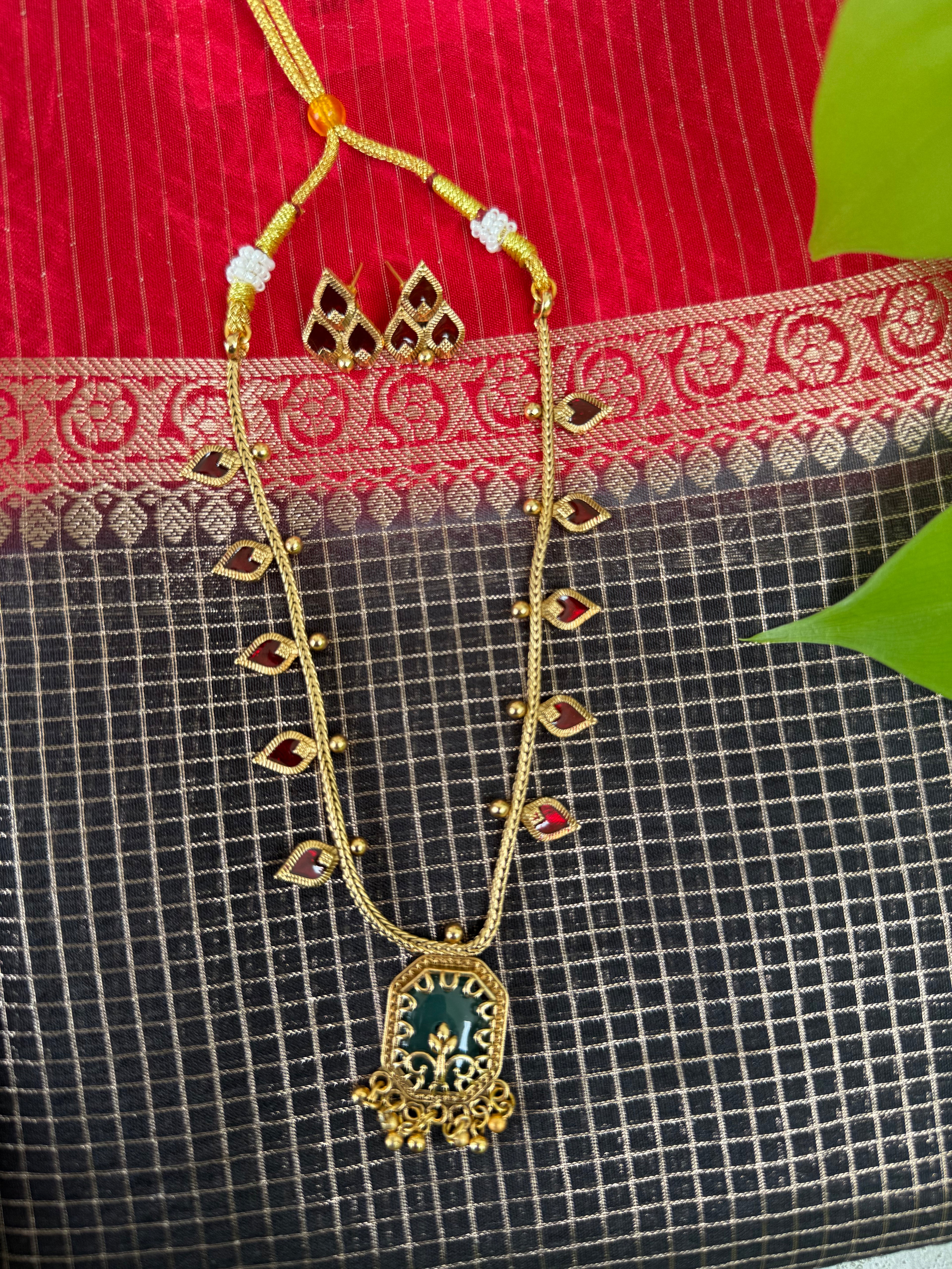 Gold Necklace with a Green Pendant