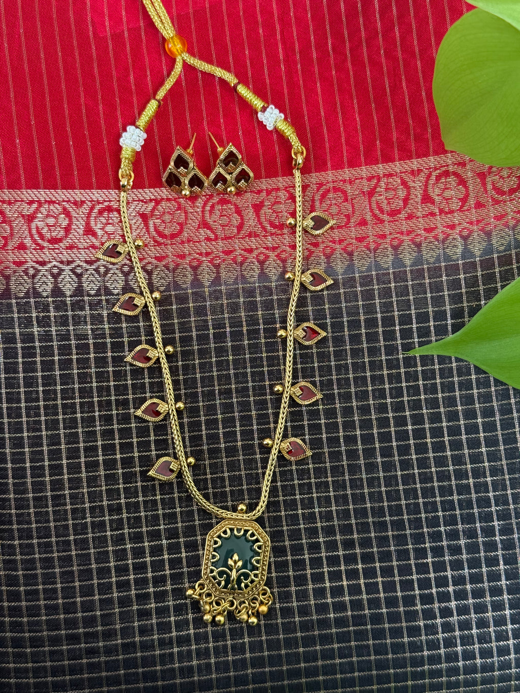 Gold Necklace with a Green Pendant