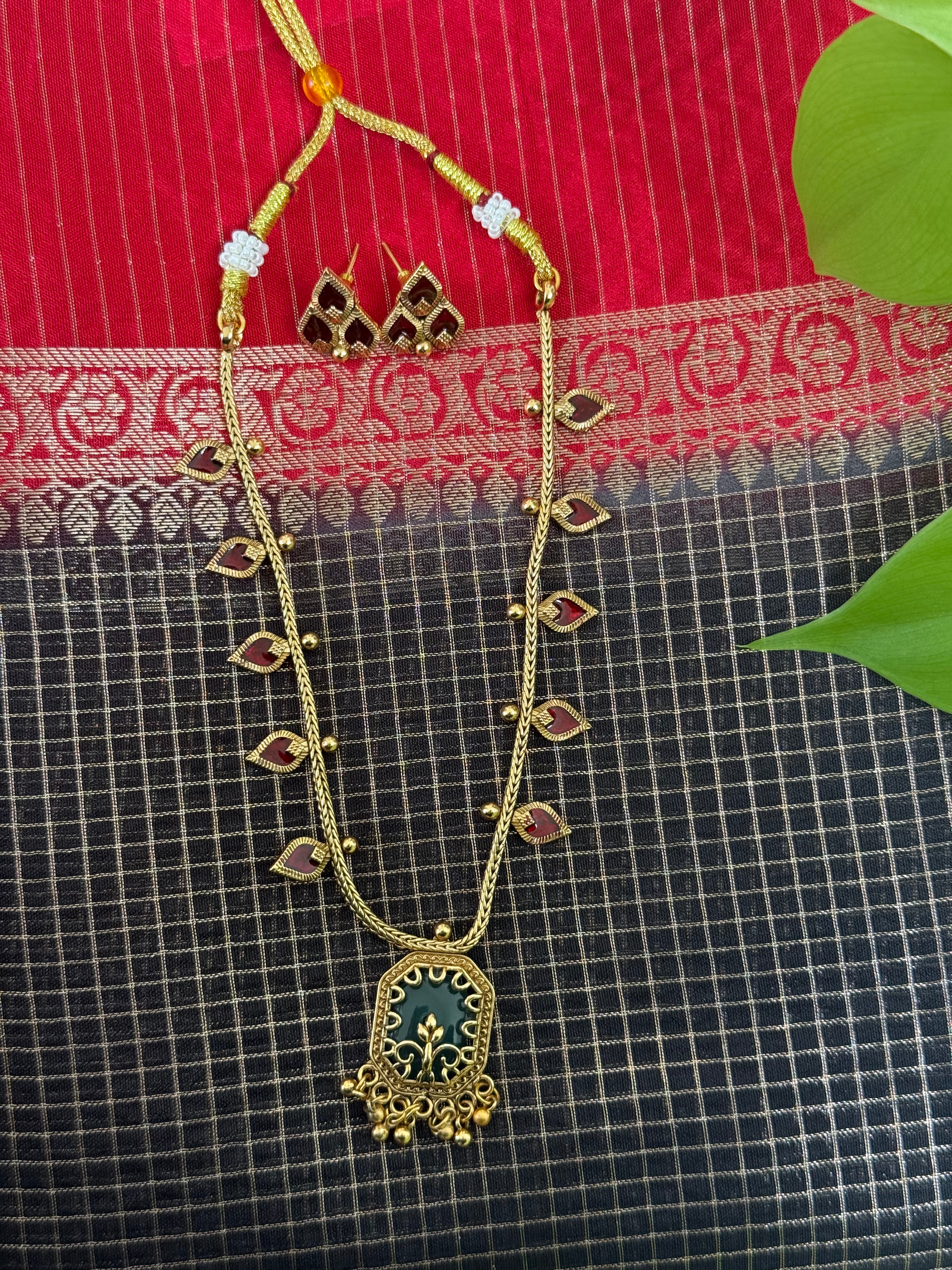 Gold Necklace with a Green Pendant