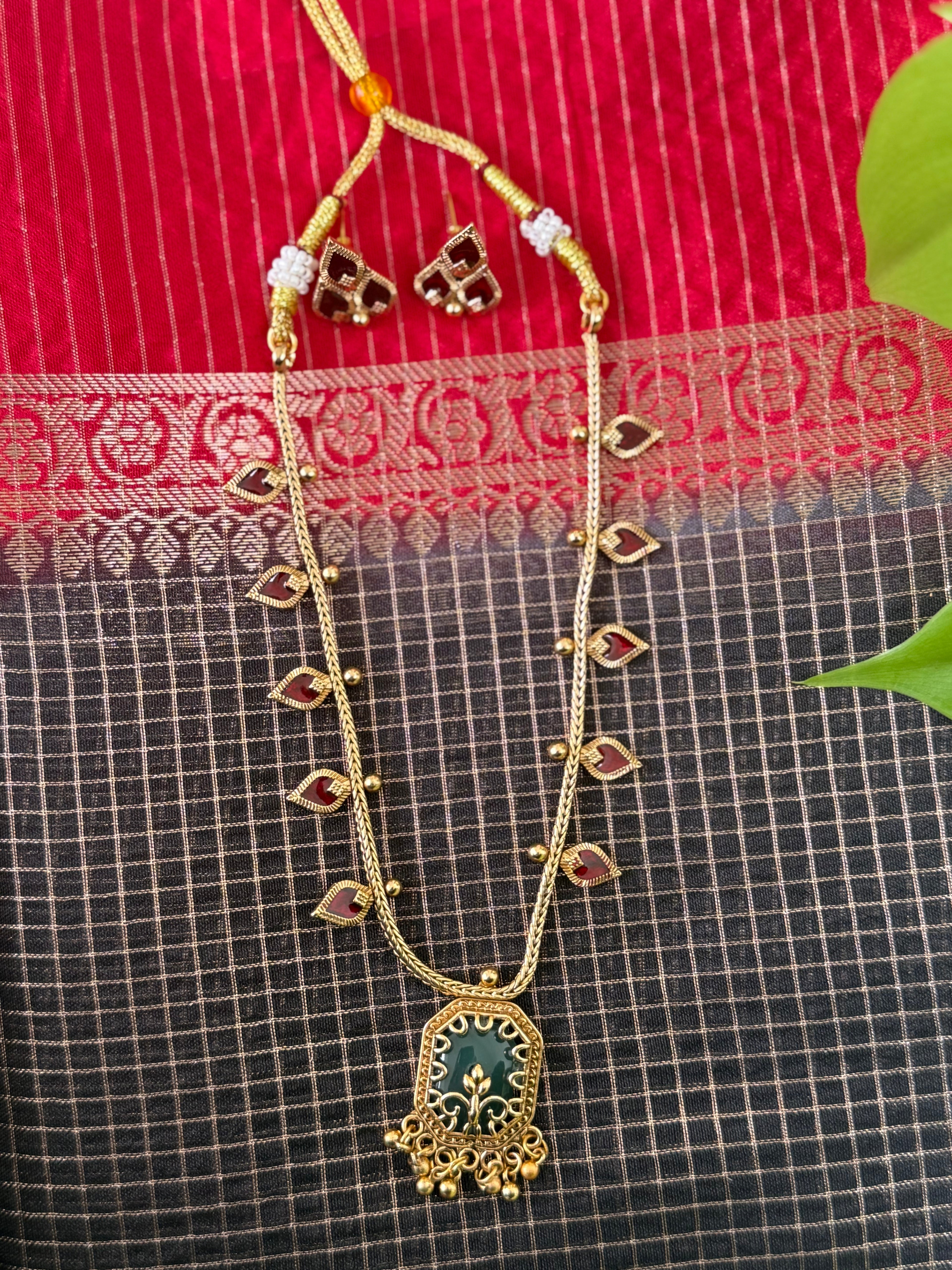 Gold Necklace with a Green Pendant